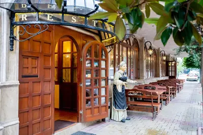 a building with a statue of a woman standing in front at Globus Hotel in Plovdiv