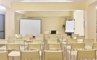 an empty room with chairs and a whiteboard at Snezhanka Hotel Pamporovo - Half Board & Swimming pool in Pamporovo