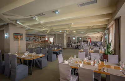 a restaurant with tables and chairs in a room at Snezhanka Hotel Pamporovo - Half Board & Swimming pool in Pamporovo