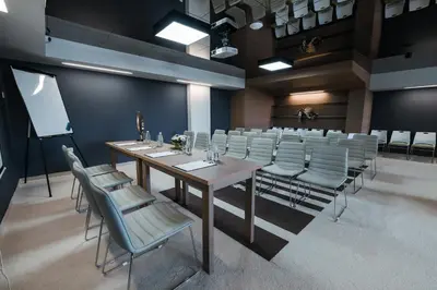 a conference room with a long table and chairs at Perelik Hotel in Pamporovo