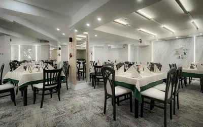 a dining room with tables and chairs and a mirror at Rhodopi Home Hotel Chepelare- Half Board & Wellness in Chepelare