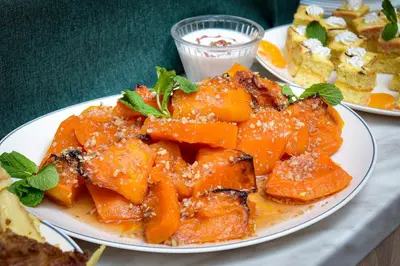 a plate of food with oranges on a table at Rhodopi Home Hotel Chepelare- Half Board & Wellness in Chepelare