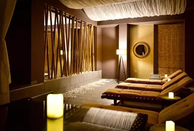 a row of beds in a room with a mirror at Rhodopi Home Hotel Chepelare- Half Board & Wellness in Chepelare
