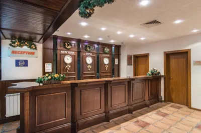 a waiting room with a bunch of clocks on the wall at Mura Hotel in Bansko