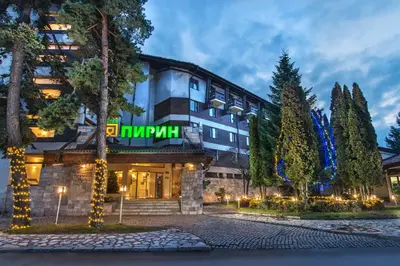 a hotel with a sign on the front of it at Hotel Pirin SKI & SPA in Bansko
