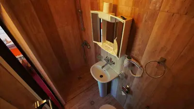 a small bathroom with a sink and a mirror at Hotel Alabin Central in Sofia