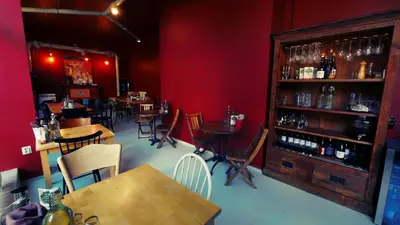 a restaurant with tables and chairs and a bar at Hotel Alabin Central in Sofia