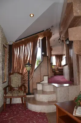 a room with stairs and a chair and a window at Boutique Hotel Boris Palace & Restaurant in Plovdiv