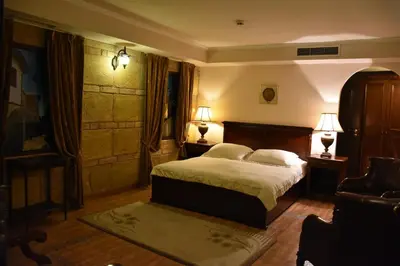 a bedroom with a bed with two lamps on it at Boutique Hotel Boris Palace & Restaurant in Plovdiv