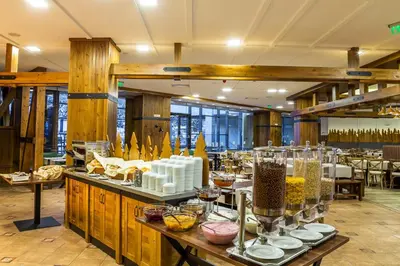 a restaurant with a buffet of food on display at Rila Hotel Borovets in Borovets