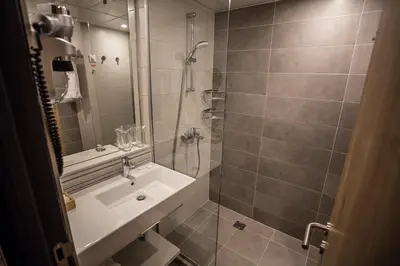 a bathroom with a shower and a sink at Rila Hotel Borovets in Borovets
