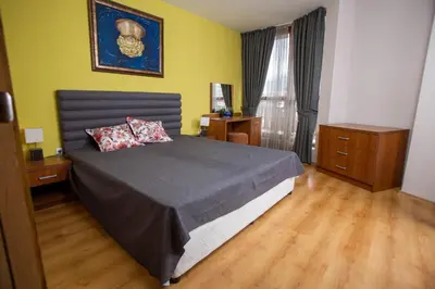 a bedroom with a bed with two pillows on it at Pirin Place Bansko in Bansko