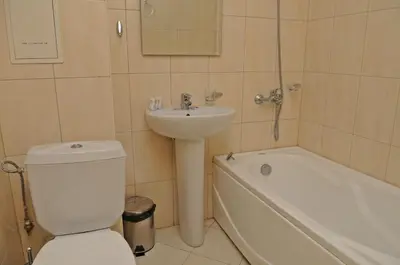 a bathroom with a sink and a toilet and a bath tub at Pirin Place Bansko in Bansko
