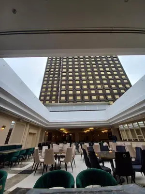 a large room with tables and chairs and a building at Astoria Grand Hotel in Sofia