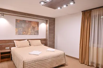 a bedroom with a bed with two towels on it at Hotel Rothmans-Breakfast - Free parking - Lobby in Bansko