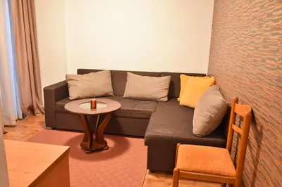 a living room with a couch and a table at Hotel Rothmans-Breakfast - Free parking - Lobby in Bansko