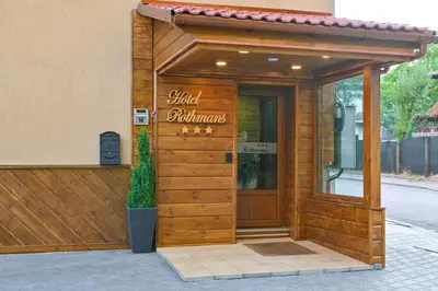 a restaurant with a sign on the front of a building at Hotel Rothmans-Breakfast - Free parking - Lobby in Bansko