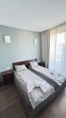 a bedroom with a bed with a bow on it at Aparthotel Aspen in Bansko