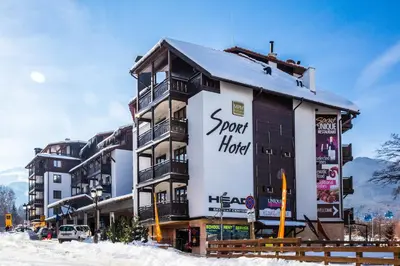 a building with a sign on it in the snow at MPM Hotel Sport Ski-in, Ski-out in Bansko