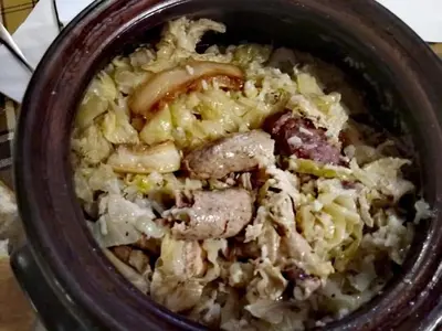 a bowl of food with meat and onions at Family Hotel Santo Bansko in Bansko
