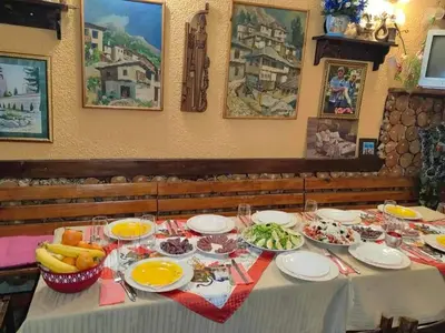 a table topped with plates and bowls of food at Family Hotel Santo Bansko in Bansko