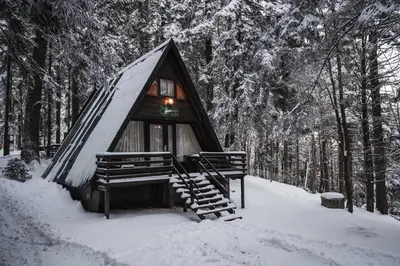 a small cabin in the woods in the snow at Villas Jagoda & Malina in Borovets