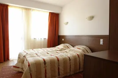 a bedroom with a bed with a blanket on it at Winslow Elegance Apartments in Bansko