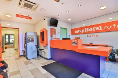 a lobby of a gas station with a colorful counter at easyHotel Sofia in Sofia