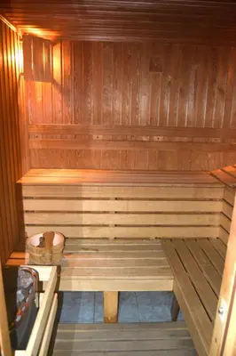 a wooden sauna with a wooden bench in it at Persey Flora Apartments in Borovets