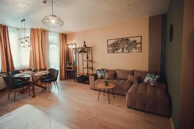 a living room with a couch and a table at Persey Flora Apartments in Borovets