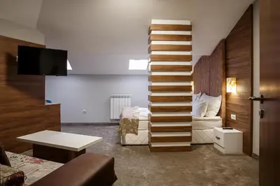 a living room with a staircase leading to a bedroom at Hotel Casa Karina Bansko - Half Board & All Inclusive in Bansko