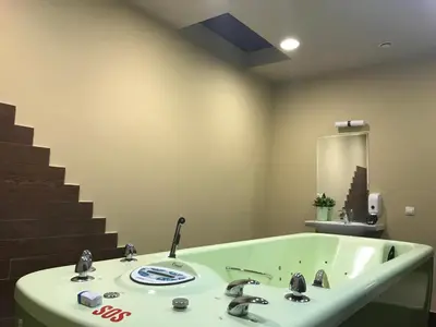 a bathroom with a bath tub with a sink at Borovets Hills Ski & Spa - Half Board in Borovets