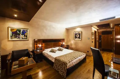 a hotel room with a bed and a desk at Hotel Anel in Sofia