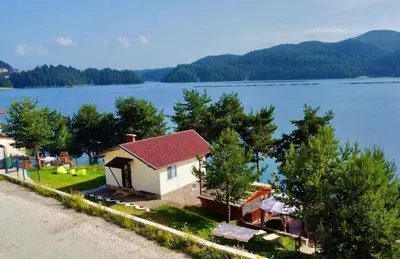 a house with a view of a body of water at Villa Eti in Dospat