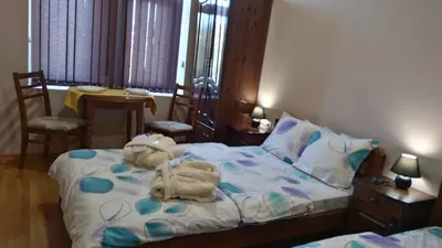 a bedroom with a bed with towels on it at Guest House Fun and Rest in Plovdiv
