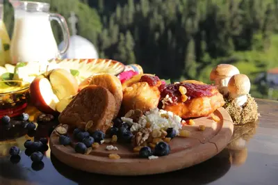 a plate of food on a wooden table at Family hotel Valchanovata Kashta in Fotinovo