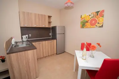 a small kitchen with a sink and a refrigerator at Guest house Traikovi in Petrich