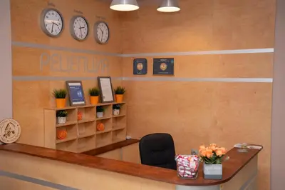a waiting room with clocks on the wall at Guest house Traikovi in Petrich