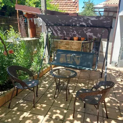 a patio with two chairs and a table and a grill at Viktoria House in Sapareva Banya