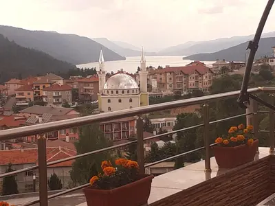 a view of a city from a balcony with flowers at Safi in Dospat