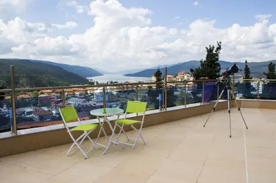 a camera on a balcony with a table and chairs at Safi in Dospat