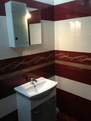 a bathroom with a sink and a mirror at Apartments Hristovi in Sandanski