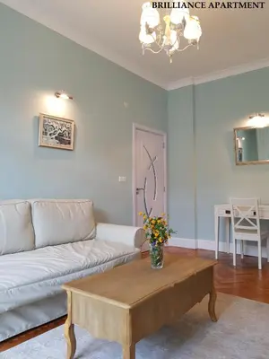 a living room with a couch and a table at Presidency House Self Check-in Apartments in Sofia