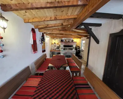 a row of chairs in a restaurant with wooden ceilings at Villa O Sole Mio in Progled