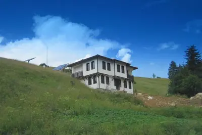 a white house on top of a grassy hill at Villa O Sole Mio in Progled