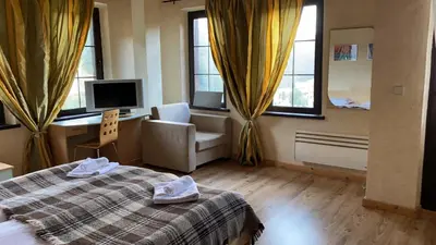 a bedroom with a bed and a chair and windows at Villa O Sole Mio in Progled