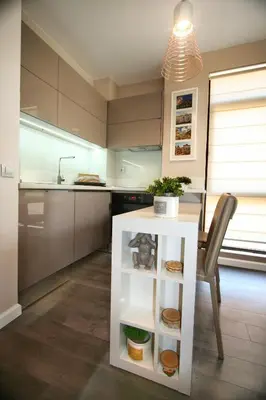 a kitchen with a white table and a chair at Holiday Apartment 7 in Hisarya