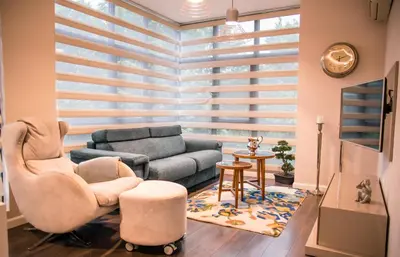 a living room with a couch and a chair at Holiday Apartment 7 in Hisarya