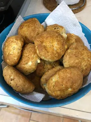 a blue bowl filled with potatoes on a table at Mountain View Vacation Home in Balabanska