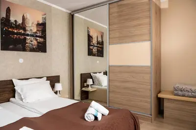 a bedroom with a bed and a large mirror at Panorama Apartment in Velingrad